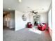 Bright loft area with two red chairs and a glass table at 4525 Cholla Trl, Castle Rock, CO 80104