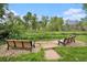 Quiet community park with benches, lush green grass, and mature trees at 8039 Lee Dr # 2, Arvada, CO 80005