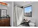 This bathroom features a single sink, shower with a curtain, and a window to view the outside at 2715 Blake St # 304, Denver, CO 80205