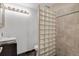 This powder room has unique glass block wall, sleek vanity, and modern fixtures for a stylish look at 2715 Blake St # 304, Denver, CO 80205
