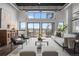 A stylish living room featuring a spiral staircase, modern seating, and bright natural light at 2715 Blake St # 304, Denver, CO 80205