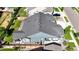 Aerial view of home showing roof, fenced backyard with lush grass and patio at 15920 Buffalo Run Dr, Commerce City, CO 80022