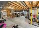 Unfinished basement featuring exposed wood ceiling, concrete floors and walls, and utility area at 15920 Buffalo Run Dr, Commerce City, CO 80022