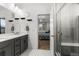 Bathroom with modern fixtures, walk in shower and entrance to the main bedroom at 15920 Buffalo Run Dr, Commerce City, CO 80022