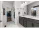 Modern bathroom featuring double sinks, granite countertop, and a separate closet at 15920 Buffalo Run Dr, Commerce City, CO 80022
