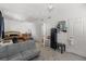Bright bedroom featuring a wooden bed frame, gray couch, and white walls at 15920 Buffalo Run Dr, Commerce City, CO 80022