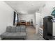 Spacious bedroom with a gray futon, wooden bed frame and a neutral color palette at 15920 Buffalo Run Dr, Commerce City, CO 80022