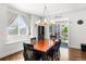 Bright dining room featuring hardwood floors, modern chandelier and sliding glass doors leading to the outdoor patio at 15920 Buffalo Run Dr, Commerce City, CO 80022