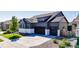 Charming two-story home with a well-manicured lawn, three-car garage and beautiful landscaping at 15920 Buffalo Run Dr, Commerce City, CO 80022