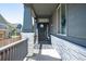 Inviting front porch with decorative columns, a stylish welcome mat, and a charming door wreath at 15920 Buffalo Run Dr, Commerce City, CO 80022