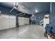 Spacious garage with epoxy flooring, blue painted walls and ceiling, and white garage doors at 15920 Buffalo Run Dr, Commerce City, CO 80022