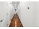 Hallway featuring hardwood floors and neutral walls, creating a clean and modern look at 15920 Buffalo Run Dr, Commerce City, CO 80022