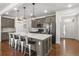 Beautiful kitchen with a center island, pendant lighting, modern appliances, and seamless flow at 15920 Buffalo Run Dr, Commerce City, CO 80022