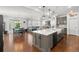 Open concept kitchen with island, dining area, and living room creates the perfect flow for gatherings at 15920 Buffalo Run Dr, Commerce City, CO 80022
