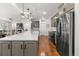 Spacious kitchen with a large island, stainless steel appliances, hardwood floors, and an open layout at 15920 Buffalo Run Dr, Commerce City, CO 80022