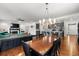Open-concept living space with hardwood floors and sight lines into the kitchen and dining area at 15920 Buffalo Run Dr, Commerce City, CO 80022