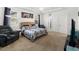 Bright main bedroom with large windows, carpeted floors, and calming color palette at 15920 Buffalo Run Dr, Commerce City, CO 80022
