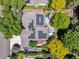 Aerial view of a house featuring solar panels, a spacious deck, lush landscaping, and a driveway at 3145 Stevens Cir, Erie, CO 80516