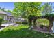 Sprawling backyard with mature trees, lush lawn, patio, gazebo, and vine-covered pergola, perfect for outdoor living at 3145 Stevens Cir, Erie, CO 80516
