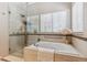 This bright bathroom has a soaking tub, a glass shower, and modern fixtures at 3145 Stevens Cir, Erie, CO 80516