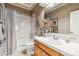 Bathroom featuring a tile shower over tub and a sink with a vanity and white tile at 3145 Stevens Cir, Erie, CO 80516