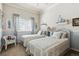 Charming bedroom with twin beds, a window and soft, inviting decor at 3145 Stevens Cir, Erie, CO 80516