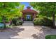 Inviting clubhouse exterior with brick facade, arched entrance, steps, and manicured landscaping at 3145 Stevens Cir, Erie, CO 80516