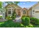 Front exterior with charming stone accents, wood door and manicured landscaping in the garden at 3145 Stevens Cir, Erie, CO 80516