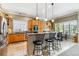 Well-lit kitchen features stainless appliances, ample cabinetry and an eat-in bar area at 3145 Stevens Cir, Erie, CO 80516
