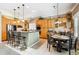 Bright kitchen with stainless steel appliances, wooden cabinetry and eat-in bar area at 3145 Stevens Cir, Erie, CO 80516