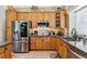 Bright kitchen showcasing stainless steel appliances and wood cabinets with ample counter space at 3145 Stevens Cir, Erie, CO 80516