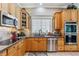 Well-lit kitchen with stainless steel appliances, wooden cabinetry and granite countertops at 3145 Stevens Cir, Erie, CO 80516