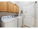 Practical laundry room with washer, dryer and overhead cabinets for storage at 3145 Stevens Cir, Erie, CO 80516