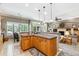 Open concept kitchen and living room featuring pendant lighting and fireplace at 3145 Stevens Cir, Erie, CO 80516