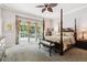 This main bedroom features a four-poster bed, ceiling fan, and private balcony access at 3145 Stevens Cir, Erie, CO 80516