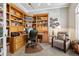 Cozy office space with built-in wooden bookshelves and a comfortable seating area at 3145 Stevens Cir, Erie, CO 80516