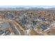 Aerial view of a neighborhood with houses, roads, and mountain background at 10092 Flower St, Broomfield, CO 80021