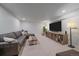 Finished basement recreation area with sectional sofa and media console at 10092 Flower St, Broomfield, CO 80021