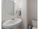 Small bathroom with pedestal sink and toilet at 10092 Flower St, Broomfield, CO 80021