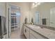 Clean bathroom with shower/tub combo and granite vanity at 10092 Flower St, Broomfield, CO 80021