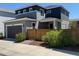 A modern home featuring an attached garage, manicured landscaping, and a fenced-in yard at 10092 Flower St, Broomfield, CO 80021