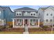 Two-story home with gray siding, brick accents, and a covered porch at 10092 Flower St, Broomfield, CO 80021