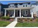 Charming two-story home with a welcoming front porch, lush lawn, and black iron fence at 10092 Flower St, Broomfield, CO 80021