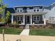 Beautiful two-story home with a charming front porch, manicured lawn, and black iron fence at 10092 Flower St, Broomfield, CO 80021