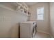 Laundry room with washer, dryer, and built-in shelving at 10092 Flower St, Broomfield, CO 80021