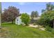 Expansive backyard featuring a well-maintained lawn, mature trees, and a storage shed at 3058 W 134Th Way, Broomfield, CO 80020