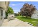 Spacious backyard with a patio area, mature trees, and a small storage shed at 3058 W 134Th Way, Broomfield, CO 80020