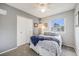 Neutral-toned bedroom with a queen bed, plush carpeting, and a view of the outside at 3058 W 134Th Way, Broomfield, CO 80020