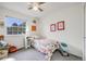 Well-lit bedroom with a single bed, floral bedding, and a view of the outside at 3058 W 134Th Way, Broomfield, CO 80020