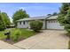 Well-maintained home with a green lawn, mature landscaping, and a paved driveway leading to a two-car garage at 3058 W 134Th Way, Broomfield, CO 80020